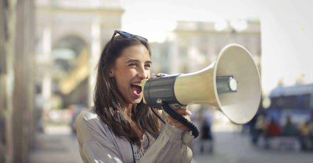 cheerful-young-woman-screaming-into-megaphone-2