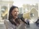 cheerful-young-woman-screaming-into-megaphone-2