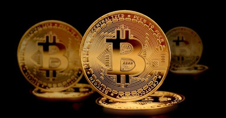 close-up-photograph-of-gold-coins-on-a-black-surface
