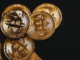 a-detailed-close-up-shot-of-shiny-bitcoin-coins-resting-on-a-glittery-surface-symbolizing-wealth-in