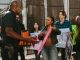 a-diverse-group-of-people-engaged-in-a-peaceful-protest-outdoors-discussing-with-a-police-officer