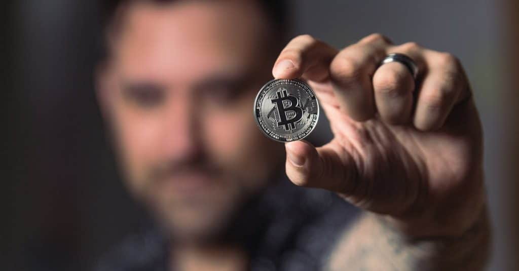 adult-male-hand-holding-a-bitcoin-showcasing-cryptocurrency-focus-indoors