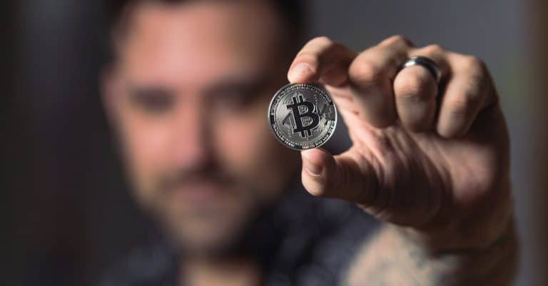adult-male-hand-holding-a-bitcoin-showcasing-cryptocurrency-focus-indoors